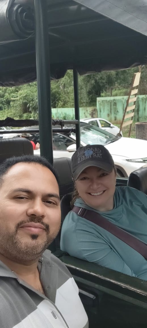 A guest and Shajid in an open safari jeep at a wildlife park